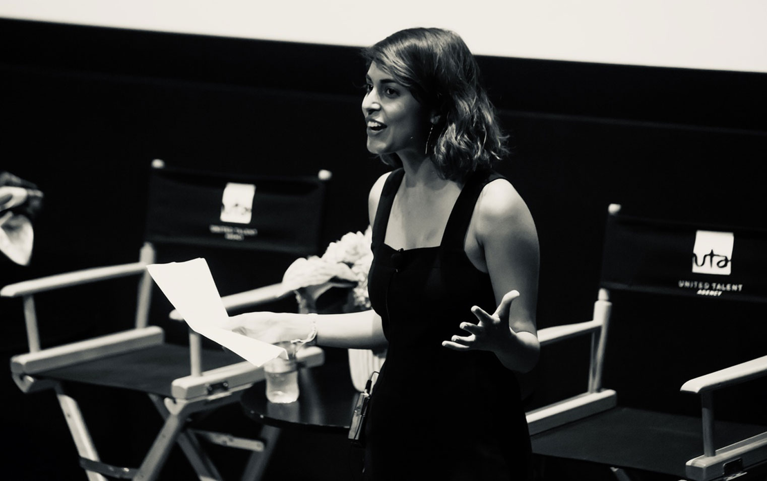 Black-and-white photo of podcast host, writer, and producer Misha Euceph moderating an event for the Secret Life of Muslims documentary series.